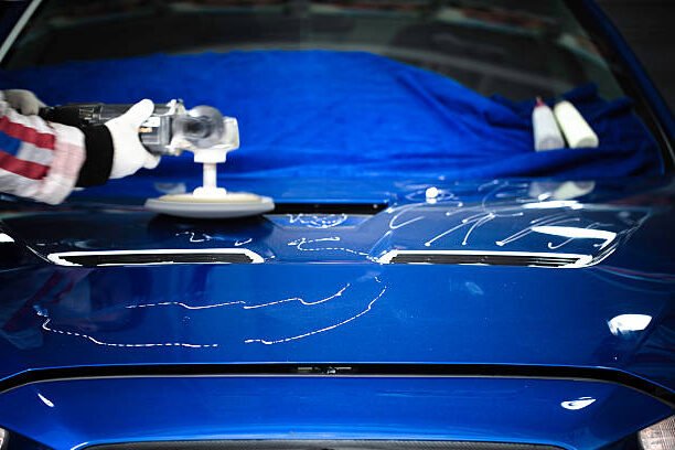 polishing the hood with wax of a japanese race car